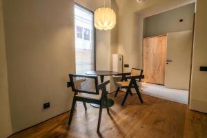 a dining room with two chairs and a table at Central Square Apartments - Центральна площа міста in Chernivtsi