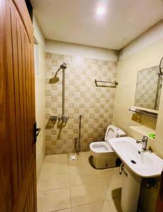 a bathroom with a sink and a toilet and a shower at Modern 2-Bedroom Apartment Only For Families in E-11 Northern strip in Islamabad