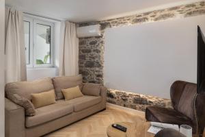 a living room with a couch and a window at Casa Branca 36 by An Island Apart in Funchal