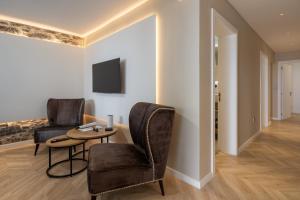 a living room with two chairs and a table at Casa Branca 36 by An Island Apart in Funchal