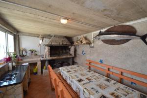 a kitchen with a table with a bed in a room at Apartmani Raić in Mali Lošinj