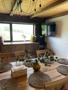 a large wooden table with a vase on top of it at Casa de Oaspeti Caezu in Slatina