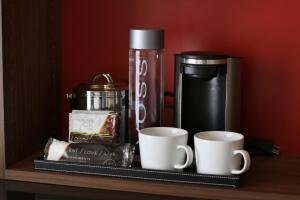 a shelf with two coffee cups and a coffee maker at Hotel Angeleno in Los Angeles