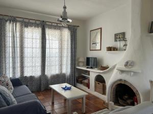 a living room with a couch and a fireplace at BERGANTIN 109 by SOM Menorca in Fornells