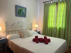 a bedroom with two red towels on a bed at BERGANTIN 109 by SOM Menorca in Fornells