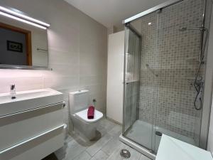 a bathroom with a shower and a toilet and a sink at BERGANTIN 109 by SOM Menorca in Fornells +20 photos