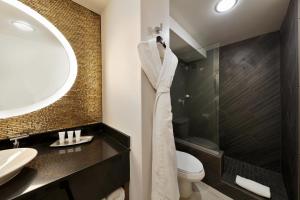 a bathroom with a sink and a toilet and a mirror at Hotel Angeleno in Los Angeles