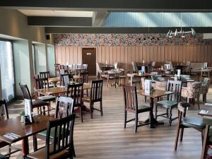 a dining room with tables and chairs in a restaurant at Abbotshall in Fife