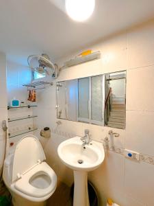a small bathroom with a toilet and a sink at Flower Homestay-Grand opening-VIP Homestay Local-Indochic-4Bedrooms in Hanoi