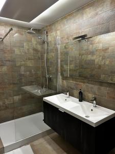 a bathroom with a sink and a shower at Dworska 24 in Ciechanowiec