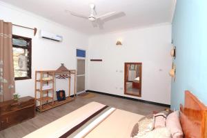 a living room with a couch and a ceiling fan at Tropical Paje Home with Pool Near the Beach in Paje