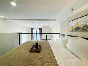 a bedroom with a large bed with a table on it at Elegant 1BR Condo - Ultra Fast WiFi - BTS On-Nut in Bangkok +30 photos