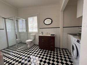 a bathroom with a black and white checkered floor at Kedumba Cottage: Gorgeous Home 2 Min Walk to Town in Katoomba