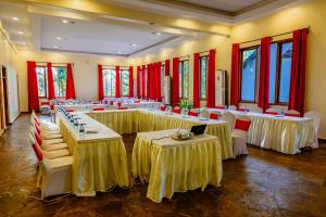 a large banquet hall with tables and chairs and a laptop at Weru Weru River Lodge in Moshi +39 photos
