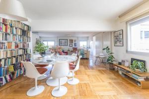 a living room with a table and chairs and bookshelves at Kuća za odmor u Bosanskoj Krupi in Bosanska Krupa