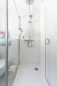 a white bathroom with a shower and a toilet at Kuća za odmor u Bosanskoj Krupi in Bosanska Krupa