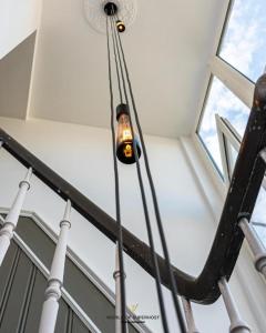 a light hanging from the ceiling of a building at Belle Epoque Villa Violette near beach and sea in Ostend