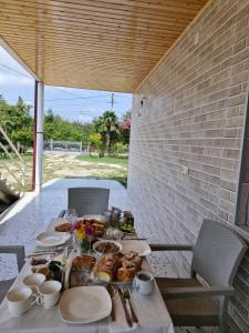 a table with food on it on a patio at Green Palms-მწვანე პალმები in Martvili
