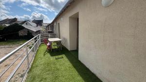 a balcony with a table and chairs on the side of a building at Duplex pour groupe au centre d'Azay Le Rideau in Azay-le-Rideau