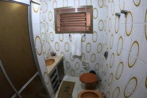 a bathroom with a toilet and a sink at MR11 Guest House in Campinas +23 photos
