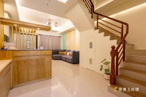 a kitchen and a living room with a staircase at 家家嵐玥 in Toucheng
