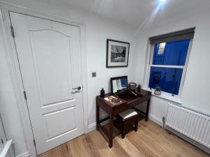 a room with a desk and a door and a window at Regency Haven in London +4 photos