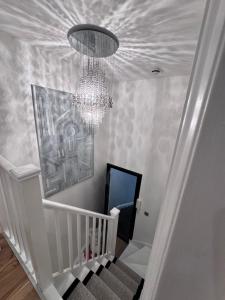 a chandelier and a staircase with a chandelier at Regency Haven in London