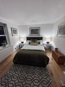 a bedroom with a large bed with two tables and two lamps at Regency Haven in London