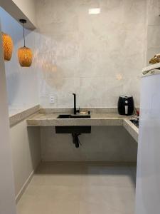 a kitchen with a sink and a counter top at Mirante do Ipiranga Apartment in Guarapari