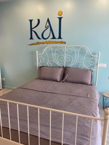 a bedroom with a bed with a k sign on the wall at KAI Condo 3 Min Walking to Beach in Donja Lastva +6 photos