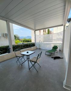 a patio with a table and chairs and a table at KAI Condo 3 Min Walking to Beach in Donja Lastva