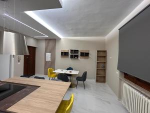 a kitchen with a table and chairs and a dining room at L Oasi di Lauria in Lauria Inferiore