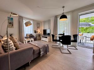 a living room with a couch and a table at Aquamarin Ostseetraumsuite 05 in Neuhaus