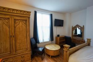 a bedroom with a bed and a table and a mirror at Bright lovely Studio in Birminghams Jewellery Quarter in Birmingham