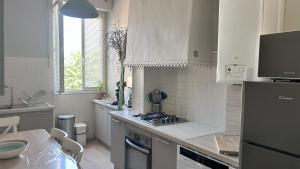 a kitchen with a sink and a stove top oven at Le Jean Moulin Vert in Sète