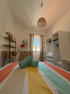 a bedroom with a bed with a parachute on the floor at Le Jean Moulin Vert in Sète