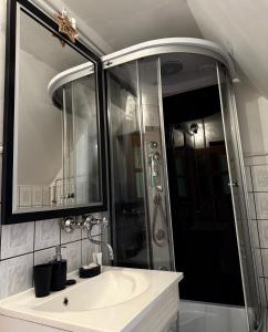 a bathroom with a white sink and a shower at Domek pod Modrzewiem in Nowy Targ +27 photos