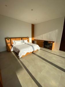 a bedroom with a bed and a desk in it at Villa Monaco - Oceanview Luxury with Private Pool in Selong Belanak +25 photos