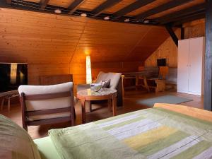 a room with a bed and a table and chairs at Bunnyhill in Elchingen