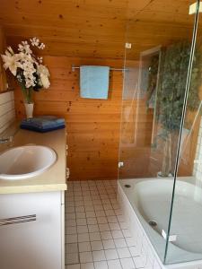 a bathroom with a tub and a sink and a shower at Bunnyhill in Elchingen +29 photos