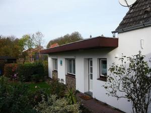 a white house with a red roof at Hus Kalli in Landkirchen +4 photos