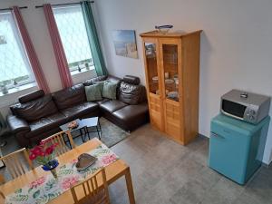 a living room with a couch and a table at Janita in Meeschendorf