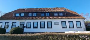 a large white house with a brown roof at Janita in Meeschendorf
