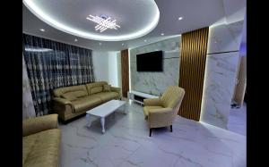 a living room with two couches and a tv at Vila Bosanski Merak in Bujanovac