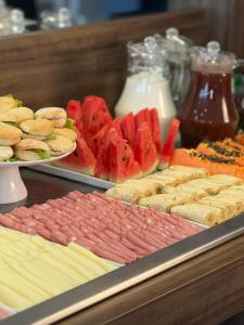 a buffet of different types of sandwiches and fruit at Dunamys Hotel Londrina in Londrina +4 photos
