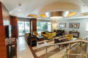 a living room with a lobby with yellow furniture at CK Farabi Hotel in Ankara