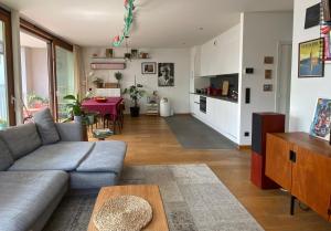 a living room with a couch and a table at Spacious & cosy apartment center in Ghent