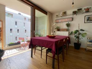 a dining room with a table with a purple table cloth at Spacious & cosy apartment center in Ghent +5 photos