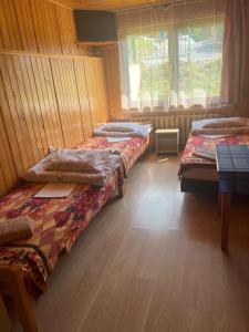 a row of beds in a room with windows at uKazika in Orawka +75 photos