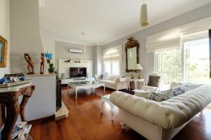 a living room with a couch and a table at Miray Guest House Boutique Hotel in Iskele